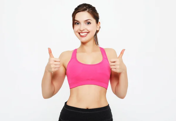 Portrait of a young fitness woman showing ok sign isolated on a — Stock Photo, Image