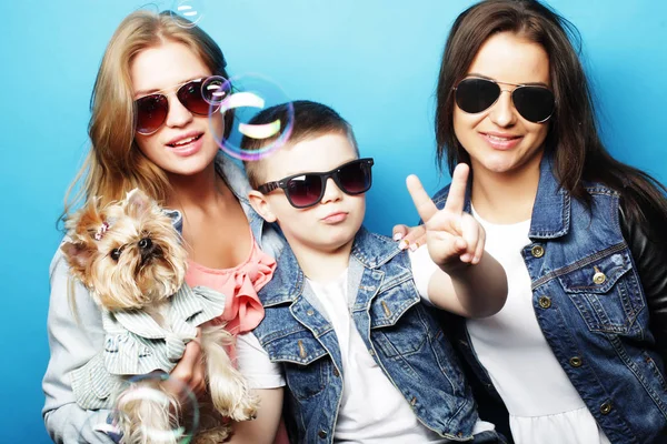 life style, happiness, emotional and people concept: brother ans two sisters, with little dog close up