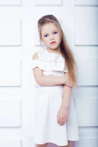 Cute little blond girl wearing white casual clothes on a white background. Fashion style. — Stock Photo, Image