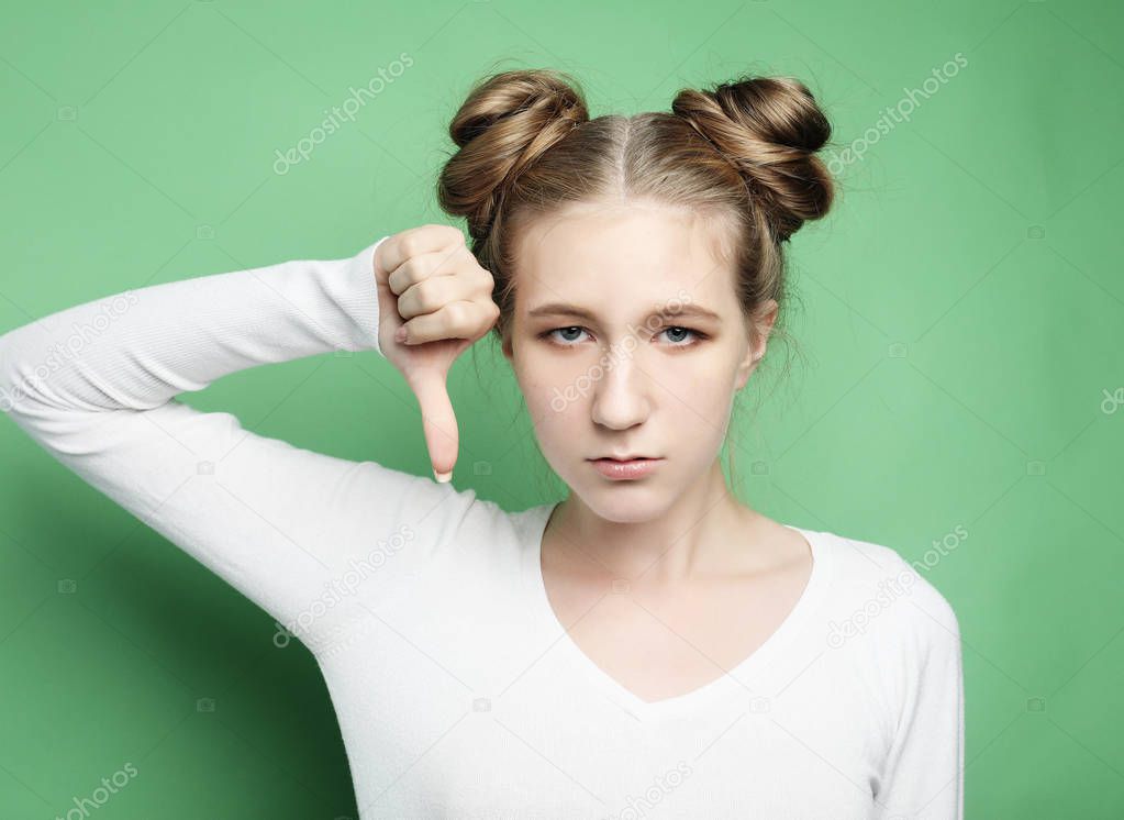 lifestyle, emotion and people concept: Woman unhappy over green background