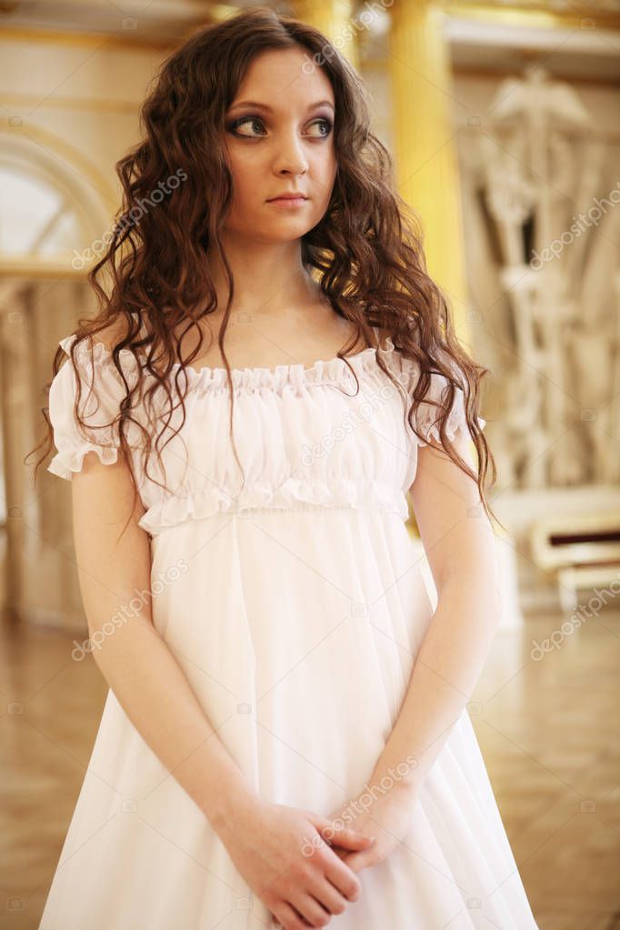 Portrait of a beautiful young victorian lady in white dress