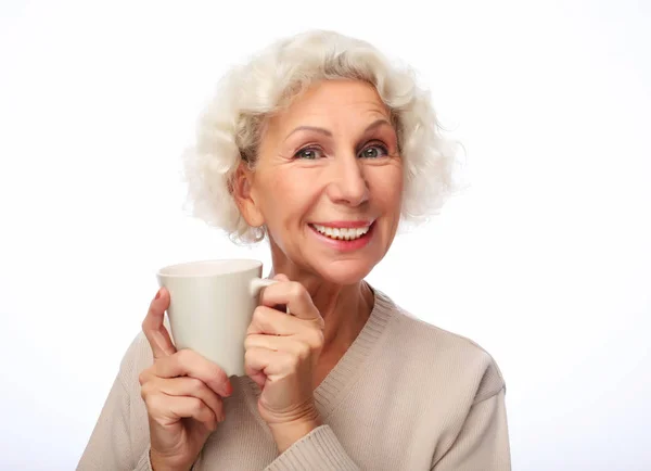 Lifestyle and people concept: old excited lady smiling laughing, holding cup drinking coffee, tea, beverage — Stock Photo, Image