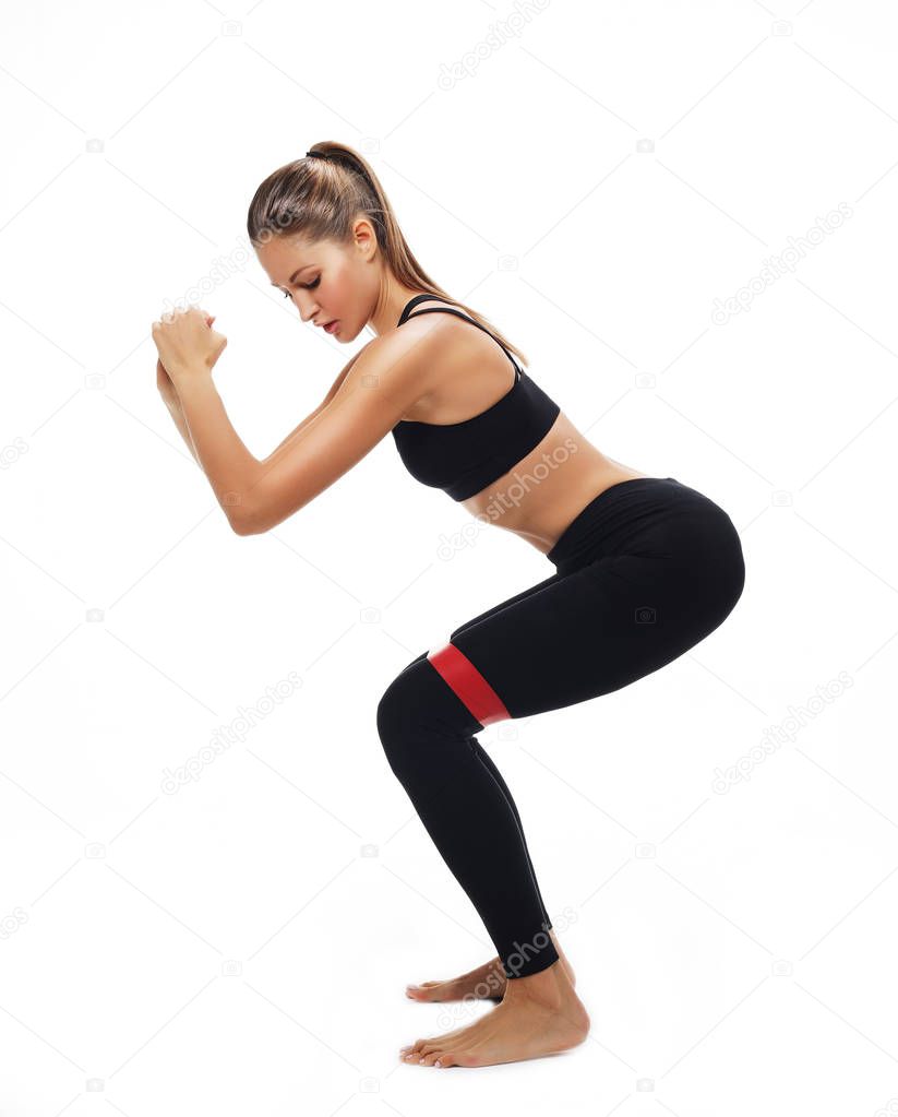 Sporty woman  doing a exersize  with resistance band. 