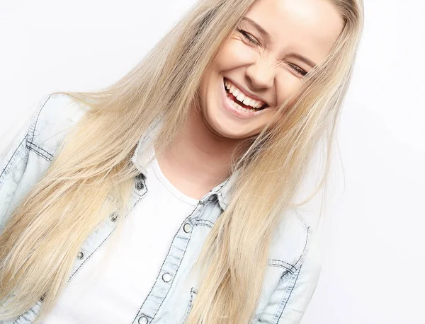 Blonde positive female with cheerful expression, dressed in casual clothes, over white background. — Stock Photo, Image