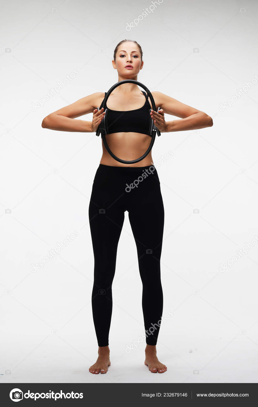 Young sporty woman with perfect body having a training with pilates ring  over white background Stock Photo by ©kanareva 232679156