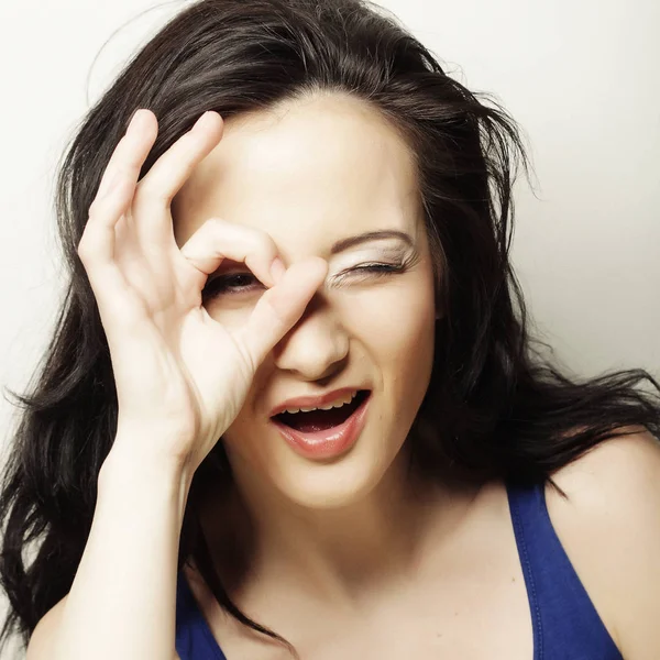 Portrait of a happy young woman doing okay sign — Stock Photo, Image