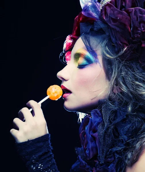 Girl with  with creative make-up holds  lollipop — Stock Photo, Image