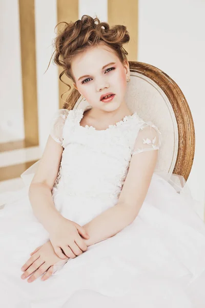 Little girl with blond hair wearing white dress. — Stock Photo, Image