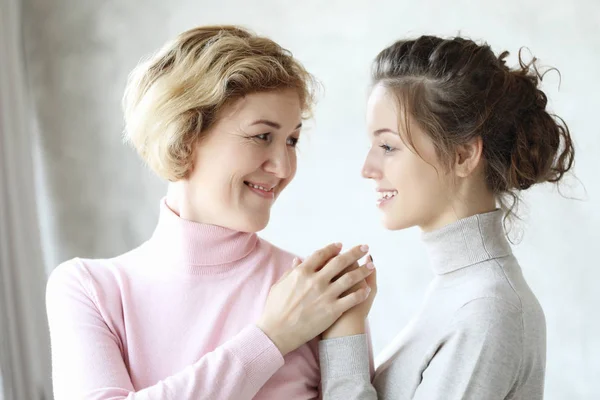 Happy senior mother embracing adult daughter laughing together, smiling excited aged older lady hugging young woman — Stock Photo, Image