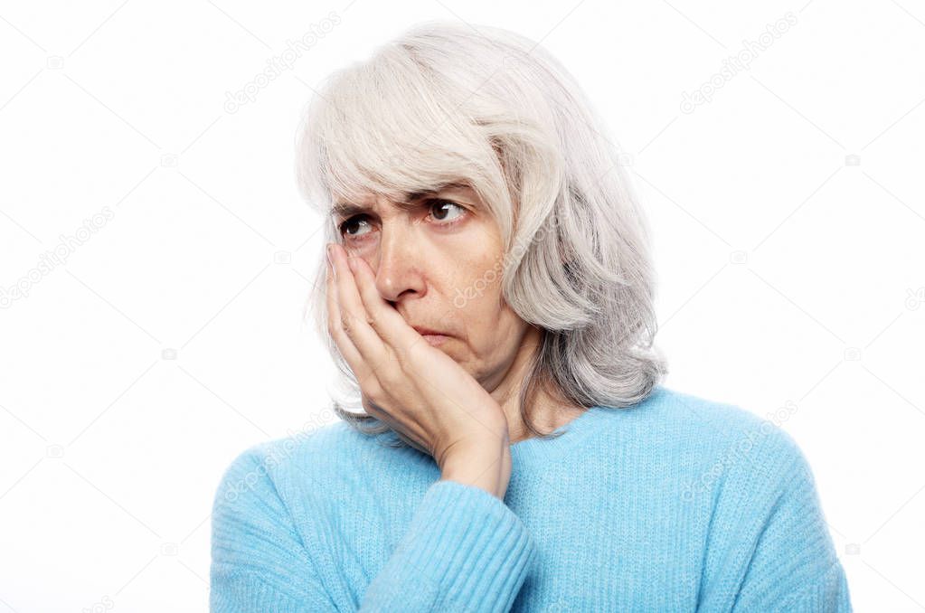 Lifestyle, health  and people concept: Elderly woman suffering from toothache on white background