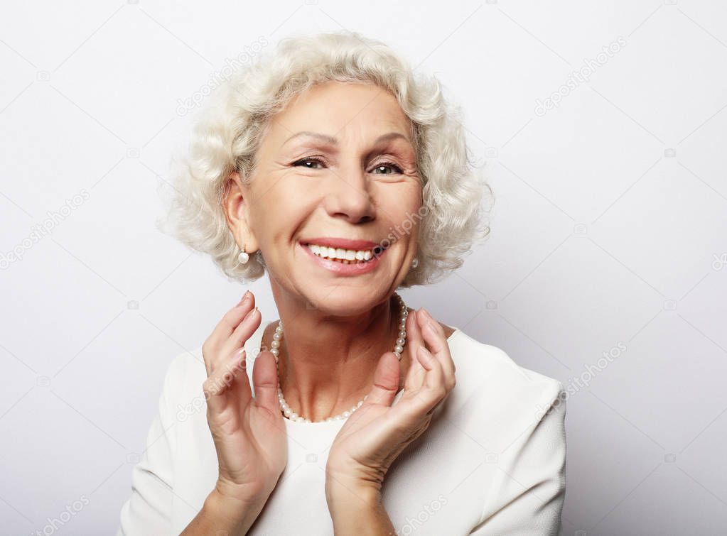 lifestyle, emotion  and people concept: Grey haired old nice beautiful laughing woman. Isolated over vwhite  background