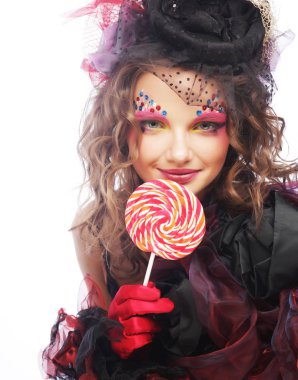 Yaratıcı makyajlı kız lolipop tutuyor. 