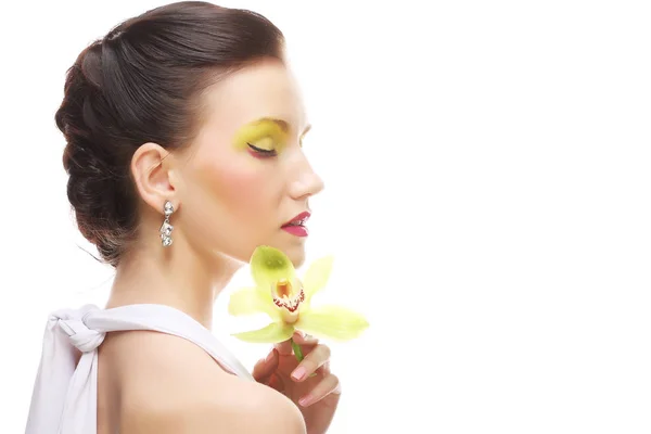 Young woman with bright make up holding orchid — Stock Photo, Image