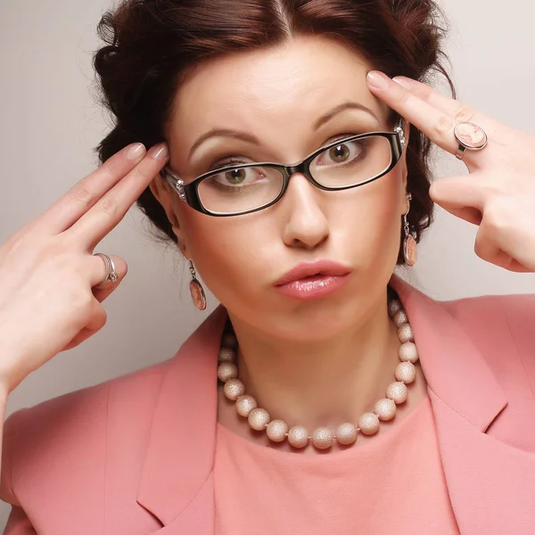Young businesswoman in pink wearing glasses — Stock Photo, Image