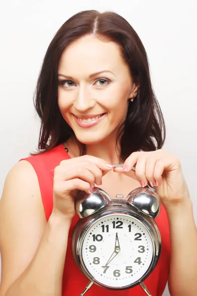 Joven mujer feliz con reloj despertador Imagen de stock