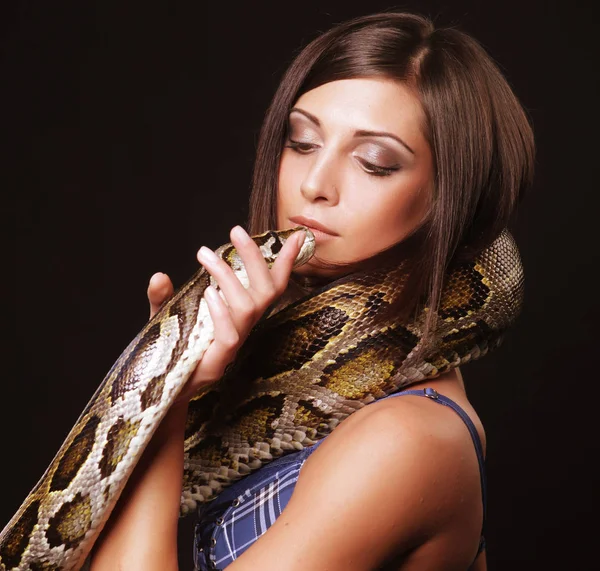 Sexy brunette holding python — Stock Photo, Image