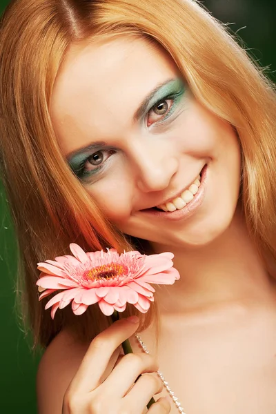 Beautiful young woman with gerber flower — Stock Photo, Image