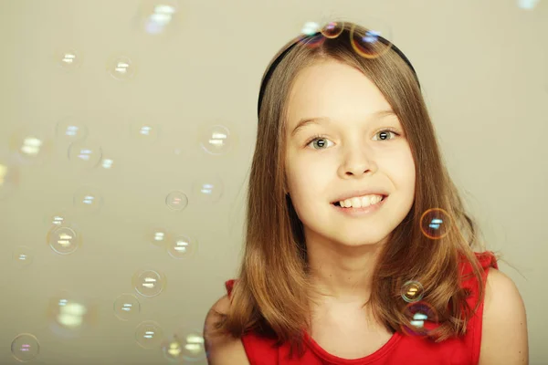 Little girl blowing soap bubbles — Stock Photo, Image