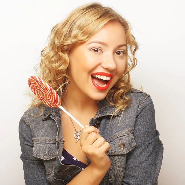 Beautiful young woman with big colorful lollipop — Stock Photo, Image