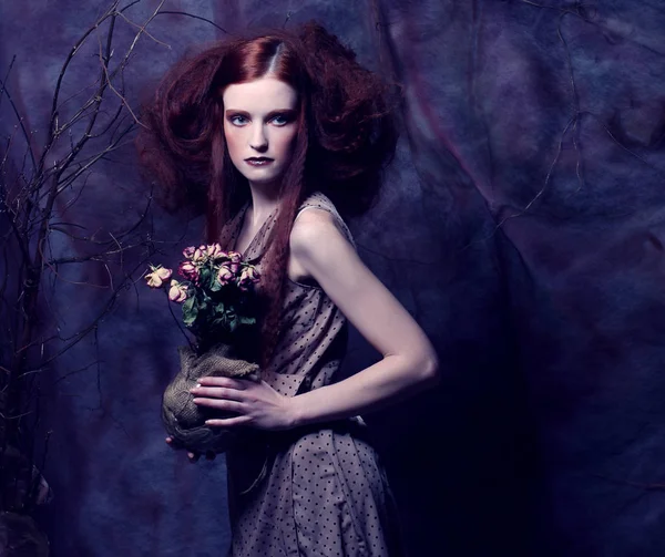 Beautiful girl with dry roses — Stock Photo, Image