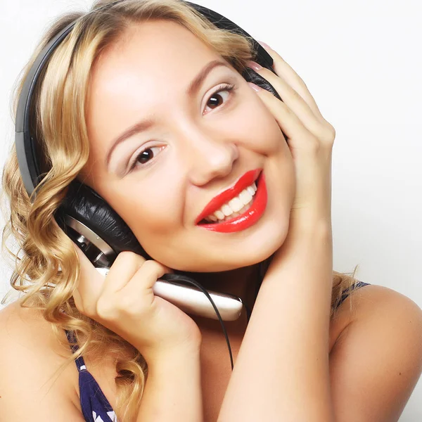 Kulaklıklı genç, mutlu bir kadın müzik dinliyor. — Stok fotoğraf