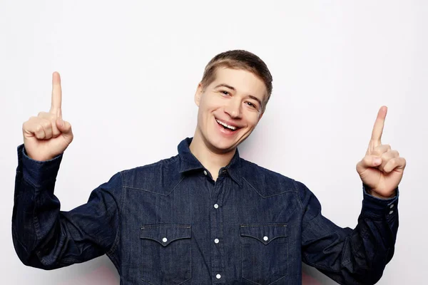 Young man pointing a great idea, isolated over a white background — Stock Photo, Image