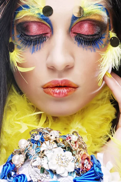 Woman with creative make up holding a bouquet of jewelry — Stock Photo, Image