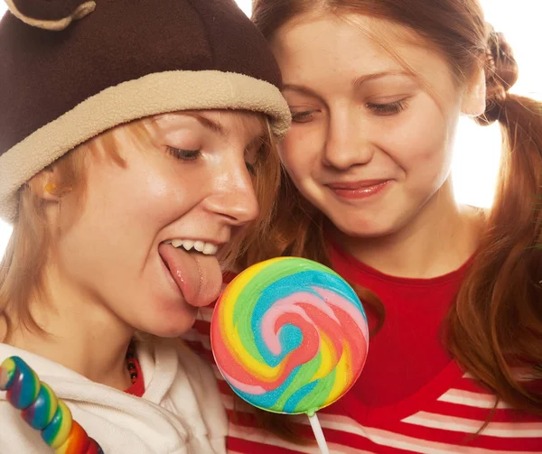 two funny girls with lolly-pop. close up