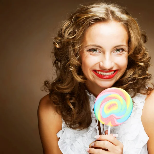 Curly  girl with a lollipop in her hand — Stock Photo, Image