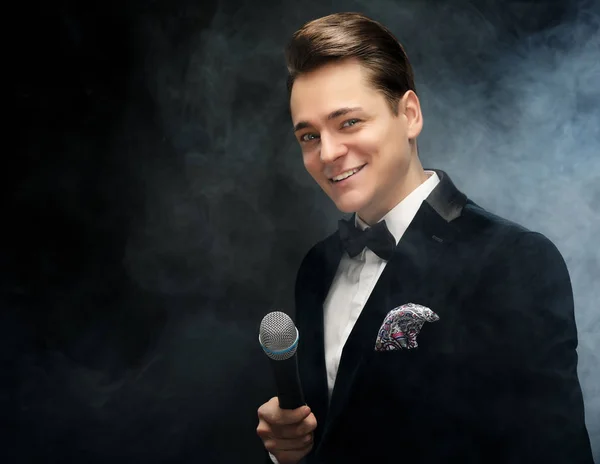 Young handsome man with microphone — Stock Photo, Image