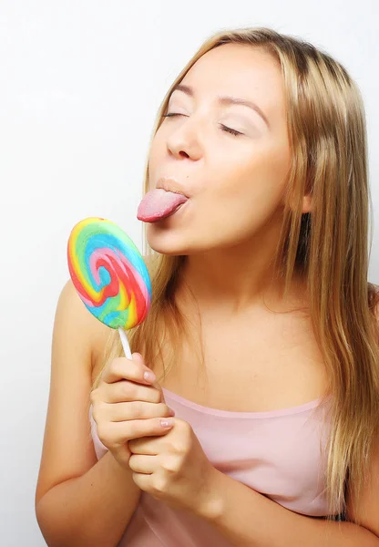 Beautiful young woman with big colorful lollipop — Stock Photo, Image