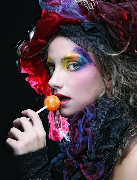 Girl with  with creative make-up holds  lollipop — Stock Photo, Image