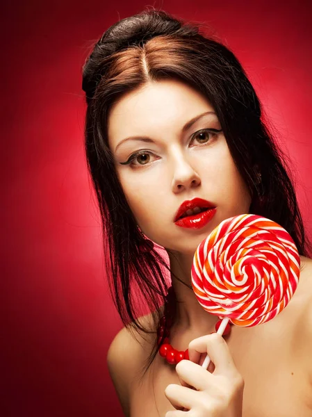 Pretty young woman holding lolly pop. — Stock Photo, Image