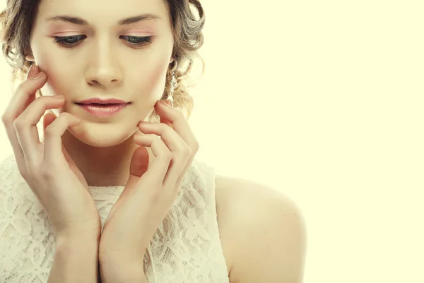 close up of beautiful woman wearing shiny diamond earrings