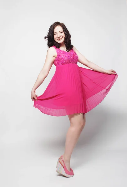 Boldog szép nő, rózsaszín ruhás portréja — Stock Fotó