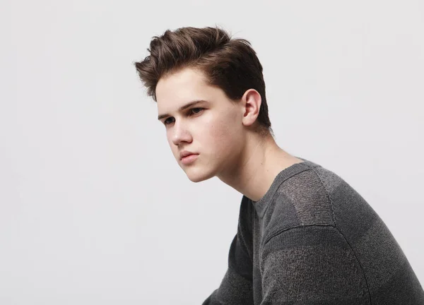 Attractive teenage boy posing in studio — Stock Photo, Image
