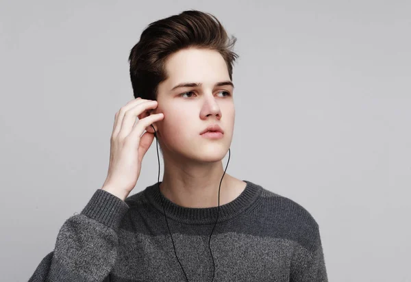 Modern teenage boy enjoys the music in headphones — Stock Photo, Image
