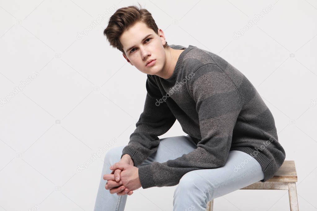 Attractive teenage boy posing in studio