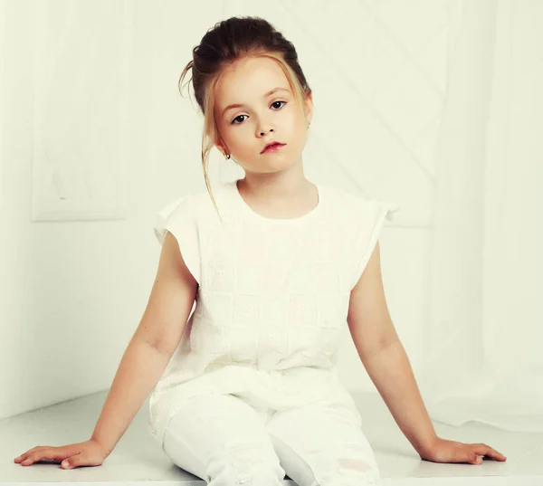 Childrens fashion. Beautiful pensive serious blonde girl in whi — Stock Photo, Image