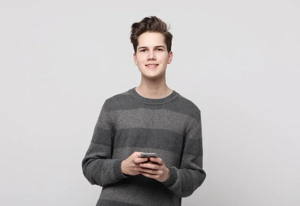 Happy young man typing sms on white background — Stock Photo, Image