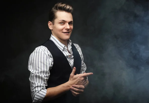 Young man model posing over dark background — Stock Photo, Image