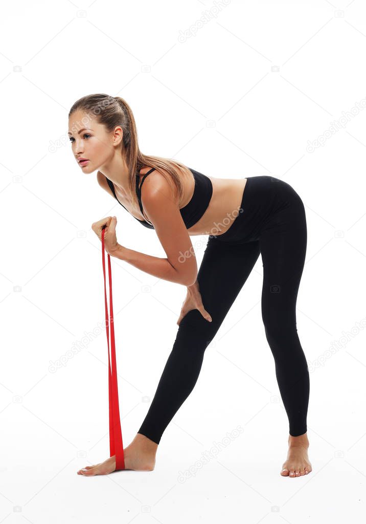Sporty woman  doing a exersize  with resistance band. 