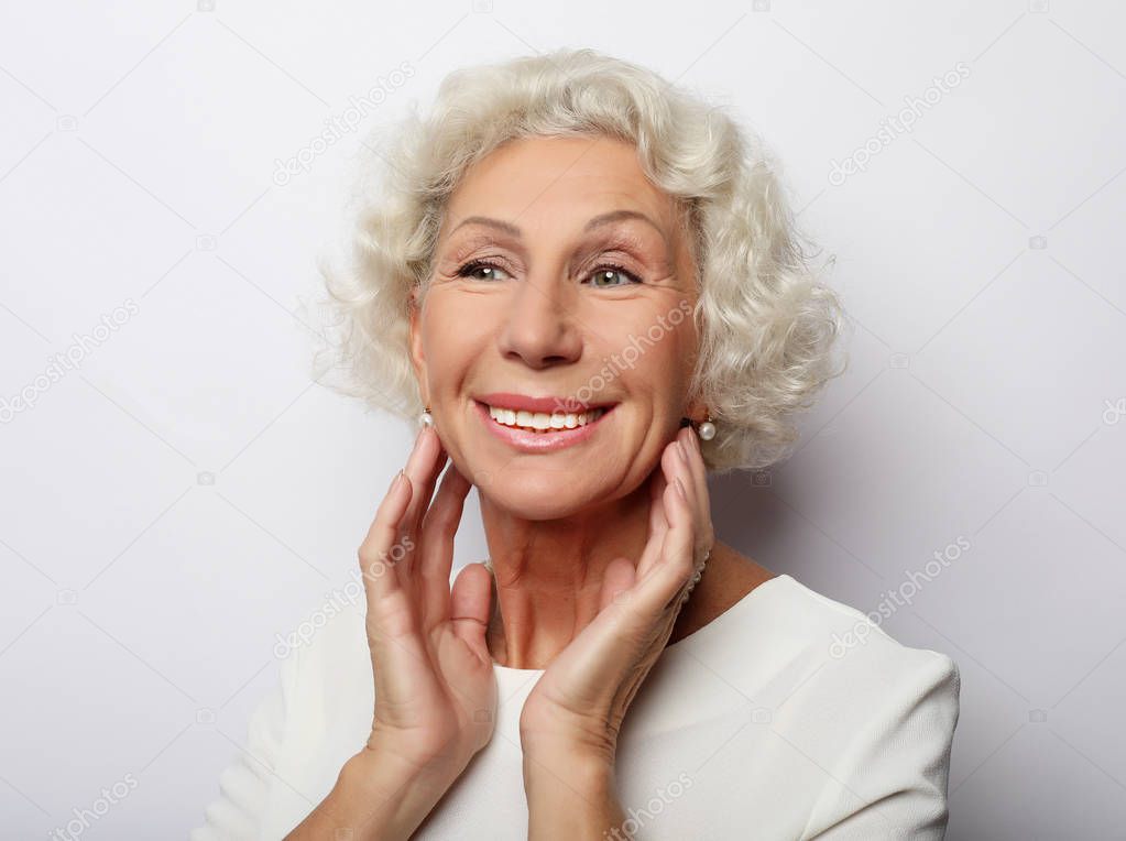 lifestyle, emotion  and people concept: Grey haired old nice beautiful laughing woman. Isolated over vwhite  background