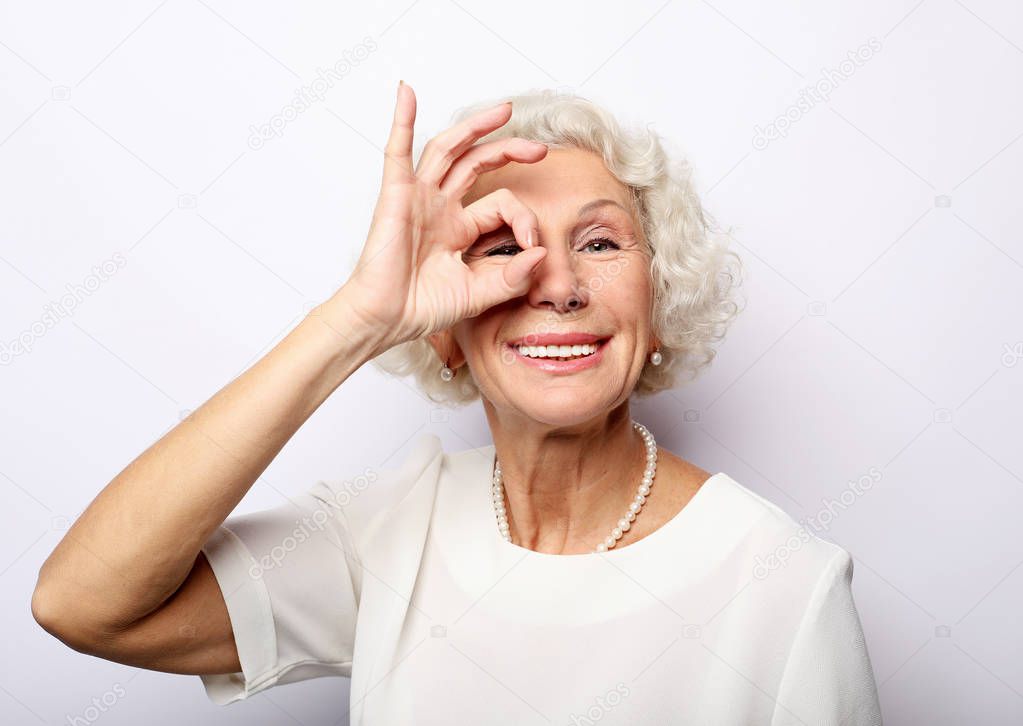 Grey haired old nice beautiful laughing woman. Isolated over vwhite background. Close up.