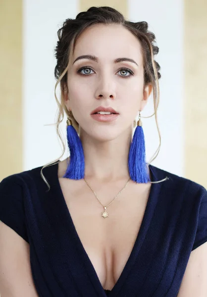 Young woman in stylish clothes with blue earrings — Stock Photo, Image