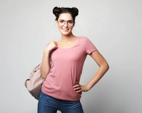 Woman with hairbuns wearing casual clothes with backpack — Stock Photo, Image