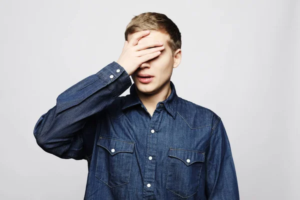 Lifestyle, health and people concept - Handsome young man suffering from headache, close up — Stock Photo, Image