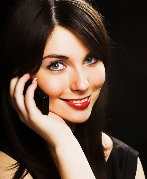 Girl talking on the phone over black — Stock Photo, Image