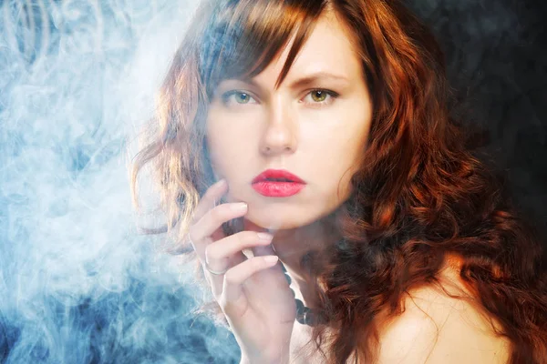 Young and sexy woman in smoke — Stock Photo, Image