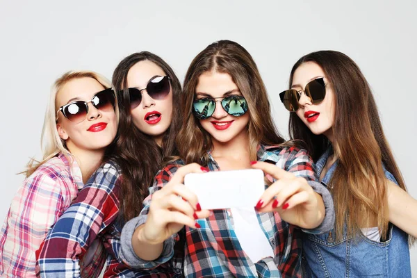 Fyra glada tonårstjejer med smartphone tar selfie — Stockfoto
